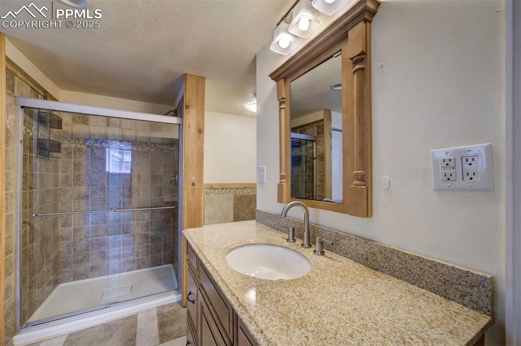 61 Louis Nelson Road Pueblo, CO 81001 - Photo 40 of 50 a bathroom with a granite countertop sink mirror and shower
