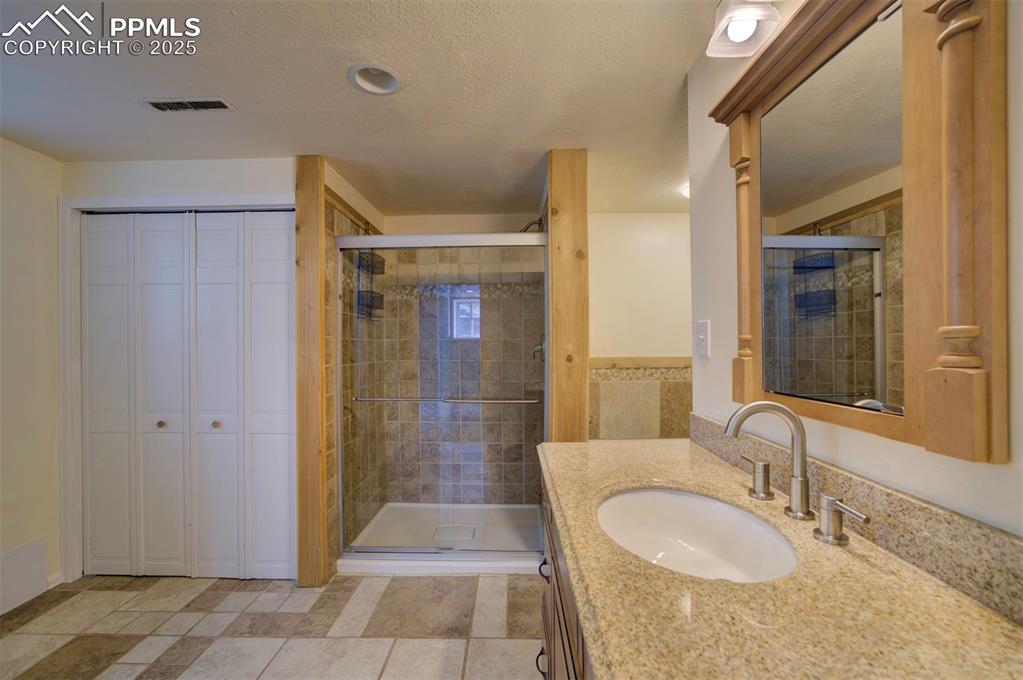 61 Louis Nelson Road Pueblo, CO 81001 - Photo 41 of 50 a spacious bathroom with a granite countertop sink a mirror and shower