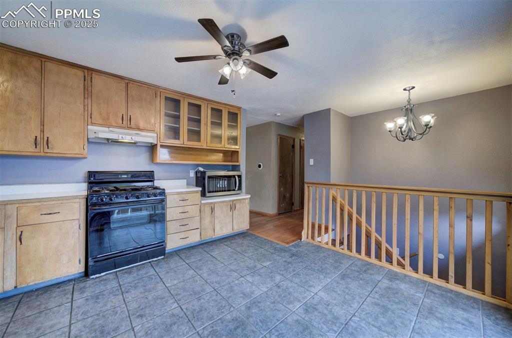 61 Louis Nelson Road Pueblo, CO 81001 - Photo 9 of 50 a kitchen with stainless steel appliances granite countertop a stove and a sink