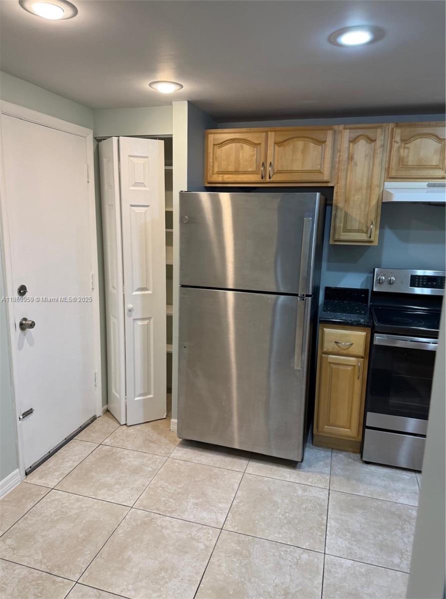 1710 Northeast 191st Street, Unit 2083 Miami, FL 33179 - Photo 13 of 36 a view of kitchen with stainless steel appliances wooden cabinet and refrigerator