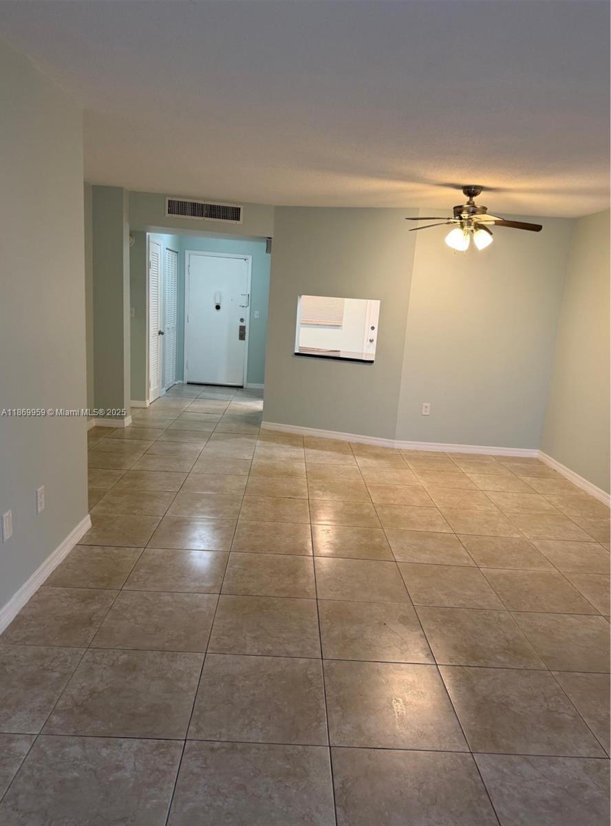 1710 Northeast 191st Street, Unit 2083 Miami, FL 33179 - Photo 17 of 36 a view of a big room with a ceiling fan and entryway