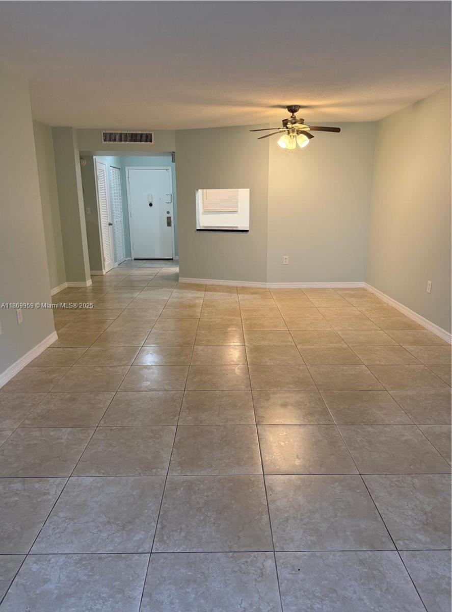 1710 Northeast 191st Street, Unit 2083 Miami, FL 33179 - Photo 19 of 36 a view of an empty room and chandelier fan
