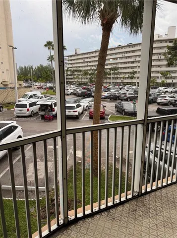 a view of balcony with floor to ceiling windows and wooden fence