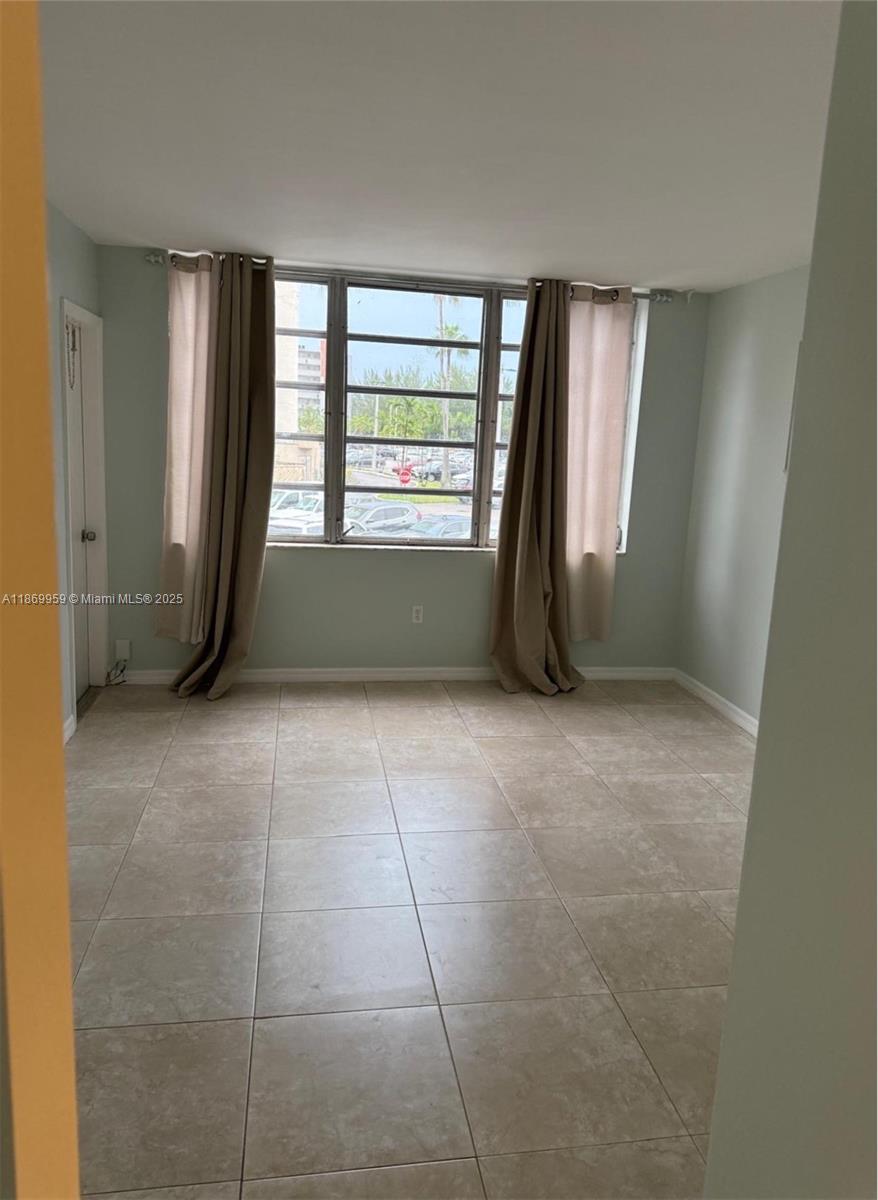 1710 Northeast 191st Street, Unit 2083 Miami, FL 33179 - Photo 4 of 36 an empty room with windows