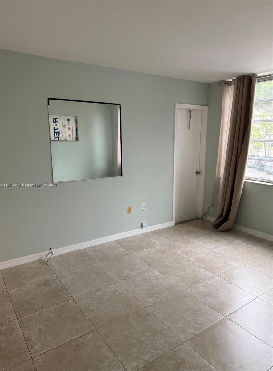 1710 Northeast 191st Street, Unit 2083 Miami, FL 33179 - Photo 5 of 36 an empty room with windows and closet
