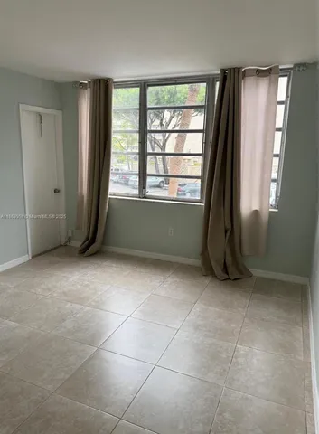 a room with a large window and a bathroom