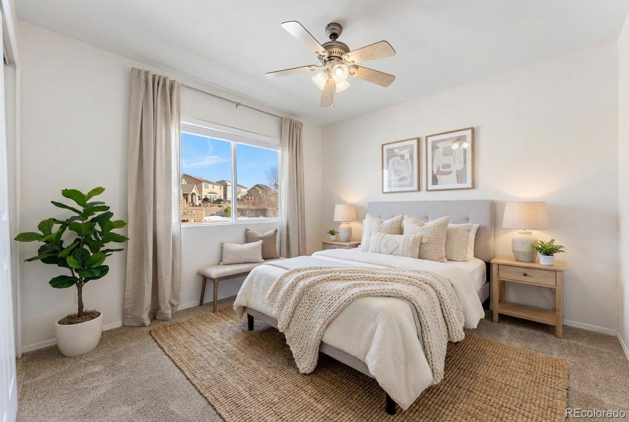 10744 Rhinestone Drive Colorado Springs, CO 80908 - Photo 12 of 24 a bedroom with a bed and a potted plant