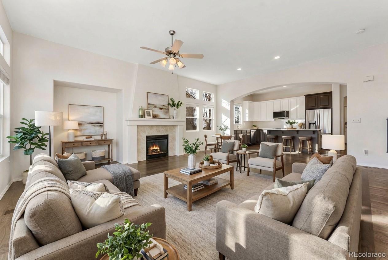 10744 Rhinestone Drive Colorado Springs, CO 80908 - Photo 2 of 24 a living room with furniture kitchen view and a fireplace