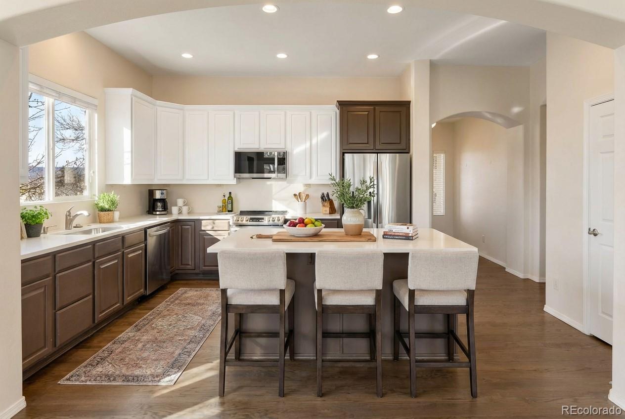 10744 Rhinestone Drive Colorado Springs, CO 80908 - Photo 3 of 24 a kitchen with kitchen island a dining table and appliances