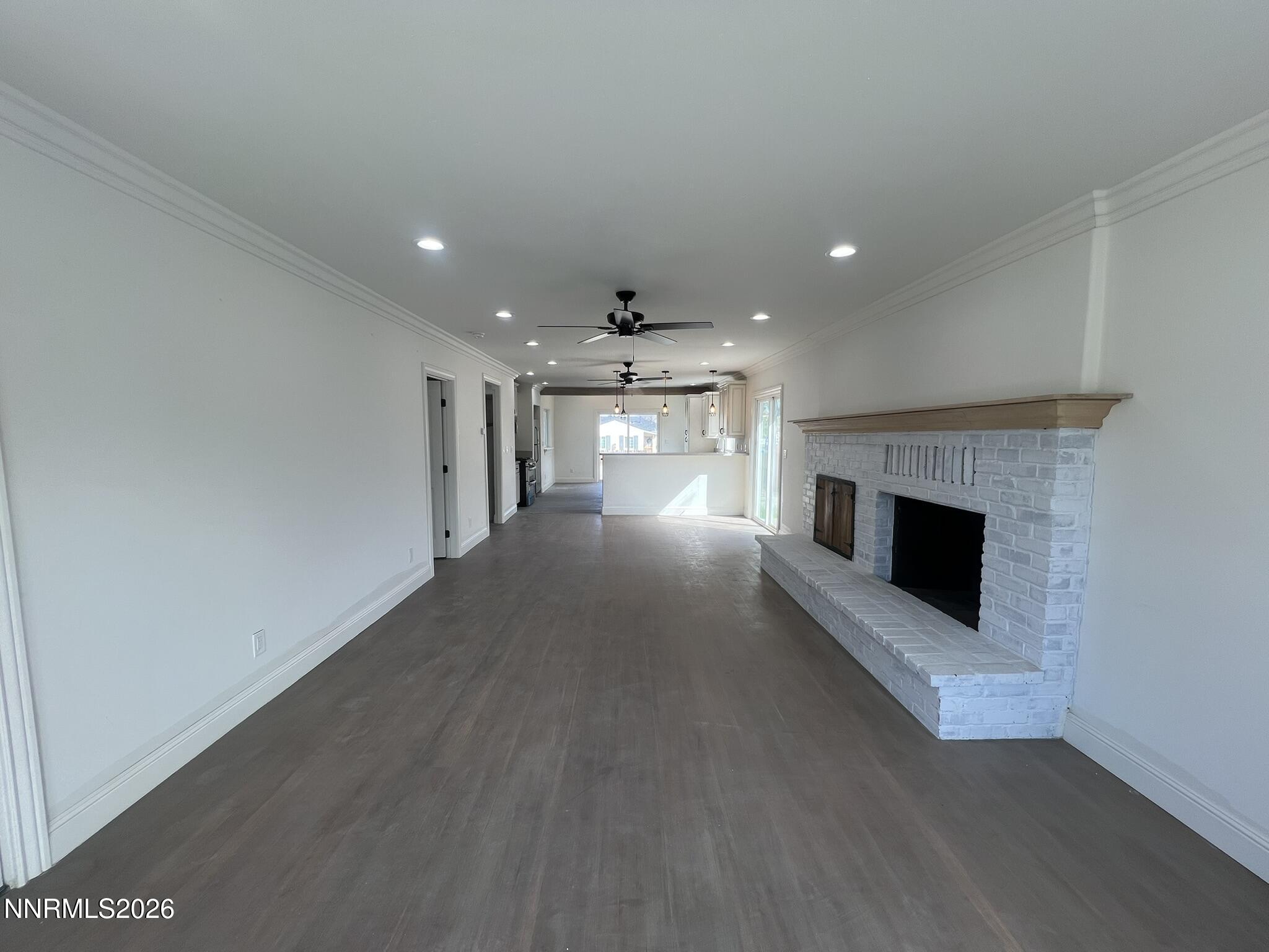 1832 H Street Sparks, NV 89431 - Photo 2 of 15 an empty room with a fireplace and window