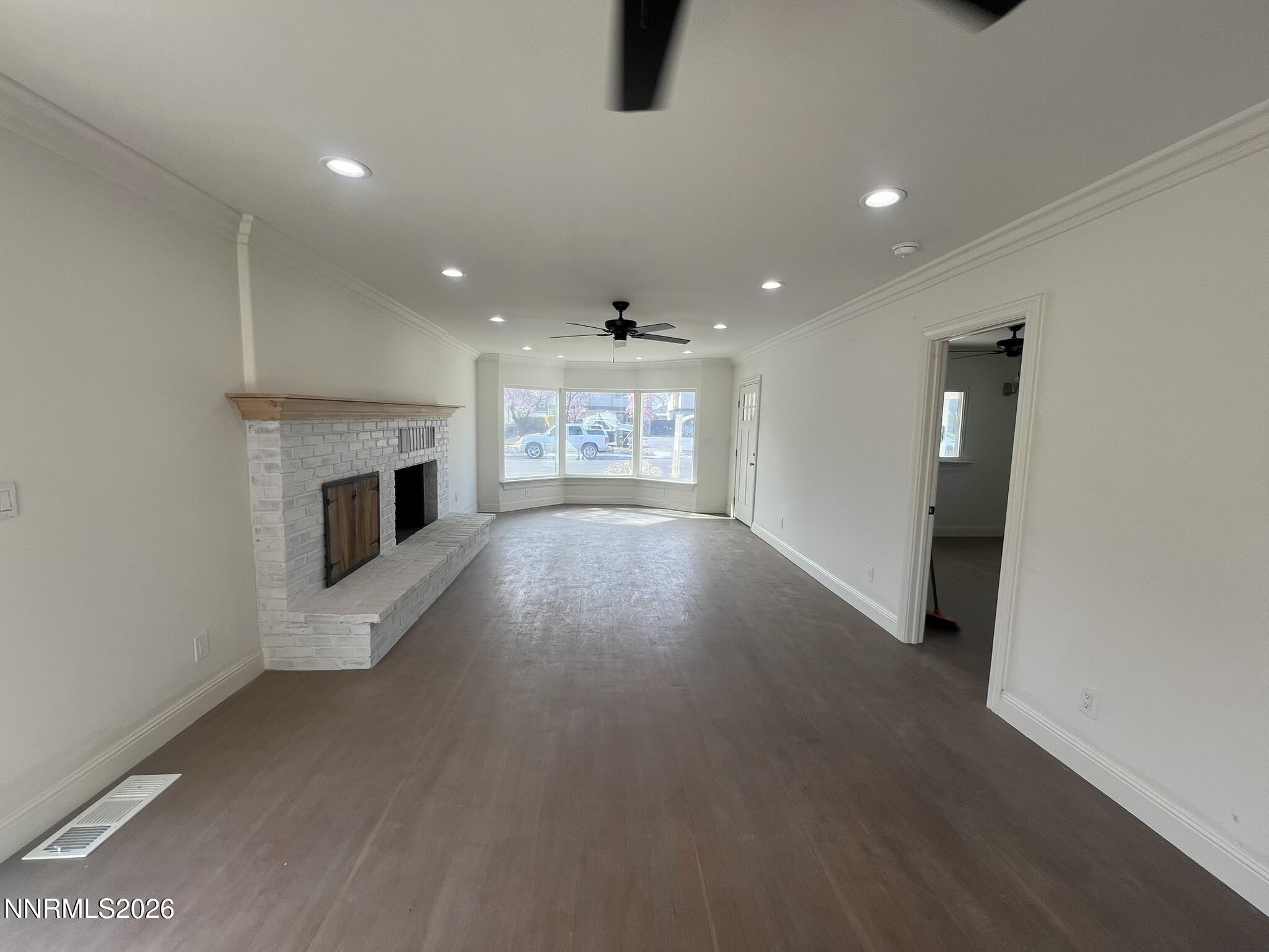 1832 H Street Sparks, NV 89431 - Photo 3 of 15 an empty room with wooden floor fireplace and windows