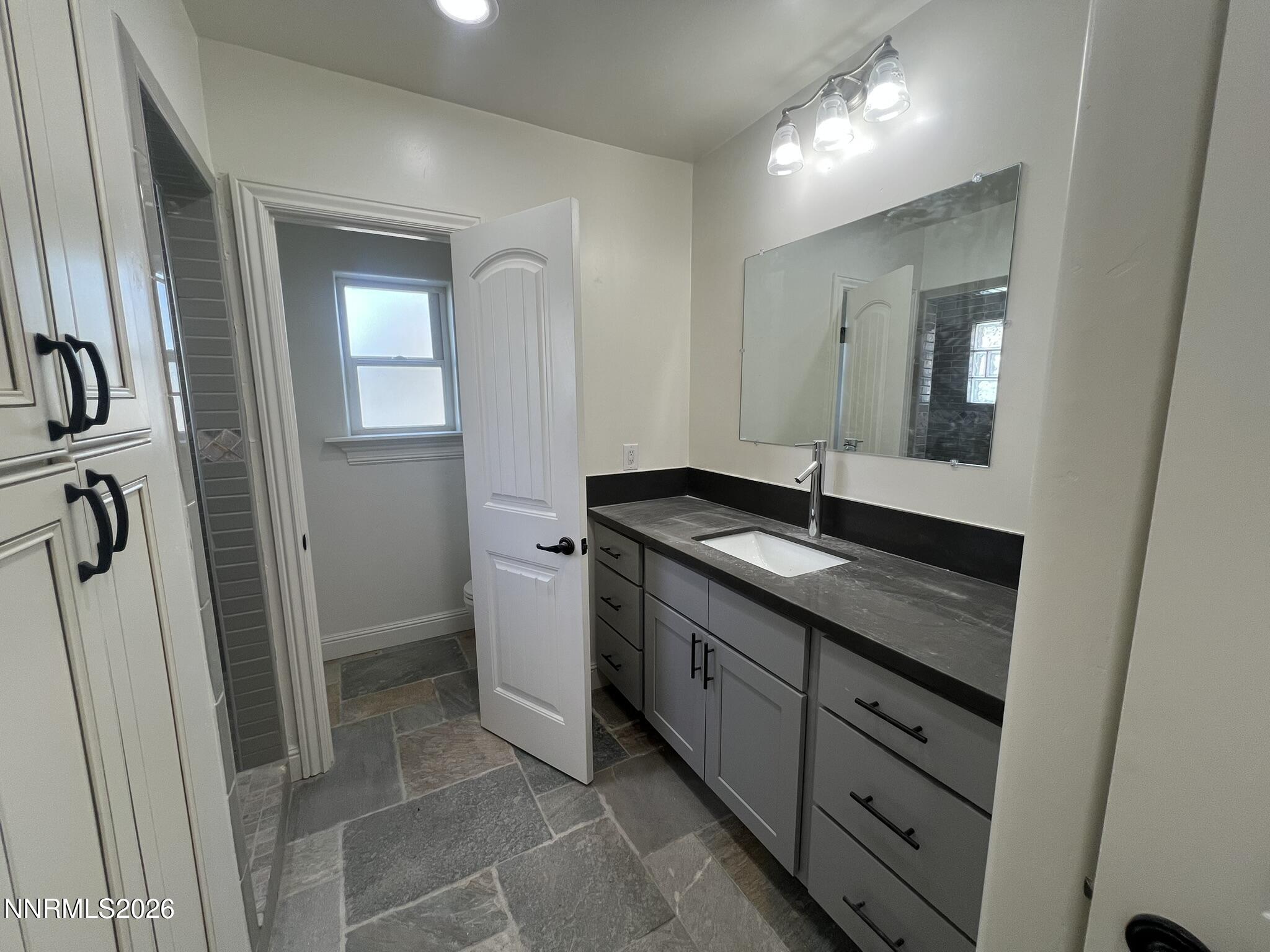 1832 H Street Sparks, NV 89431 - Photo 9 of 15 a bathroom with a double vanity sink and mirror