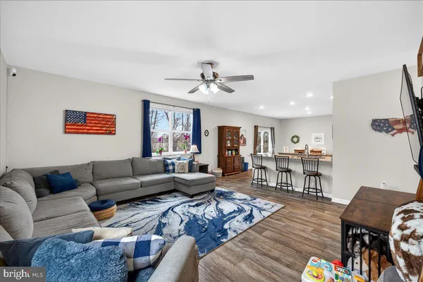 a living room with furniture and wooden floor