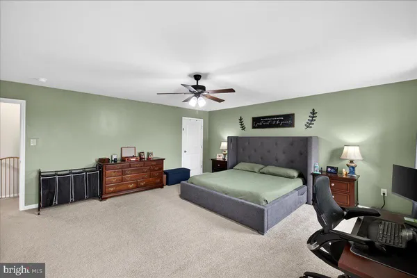 a bedroom with furniture and a flat screen tv