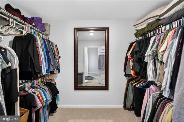 a white toilet sitting next to a shower