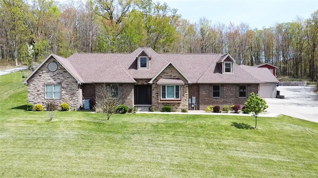 a view of a house with a yard patio and sitting area