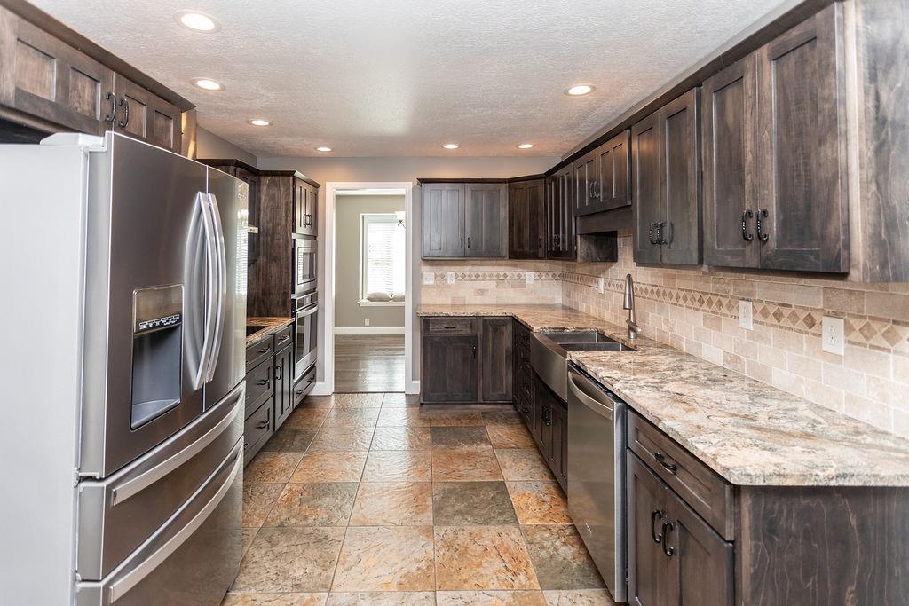 159 Reservoir Hill Road Uniontown, PA 15401 - Photo 14 of 50 a kitchen with stainless steel appliances granite countertop a refrigerator and a sink