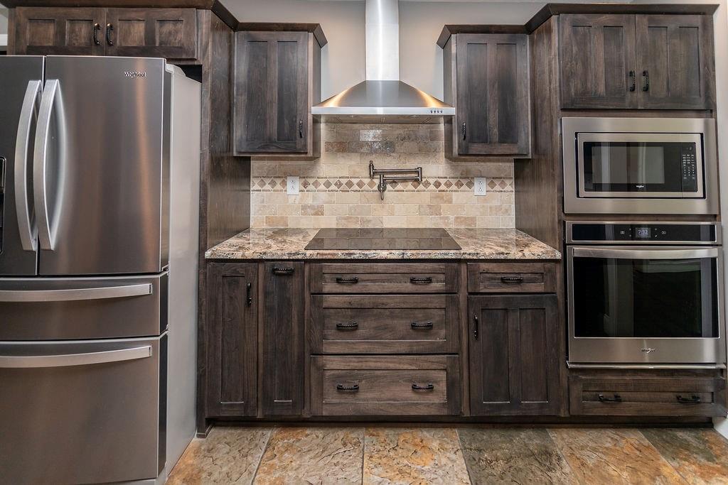 159 Reservoir Hill Road Uniontown, PA 15401 - Photo 15 of 50 a kitchen with granite countertop a stove and a refrigerator with cabinets