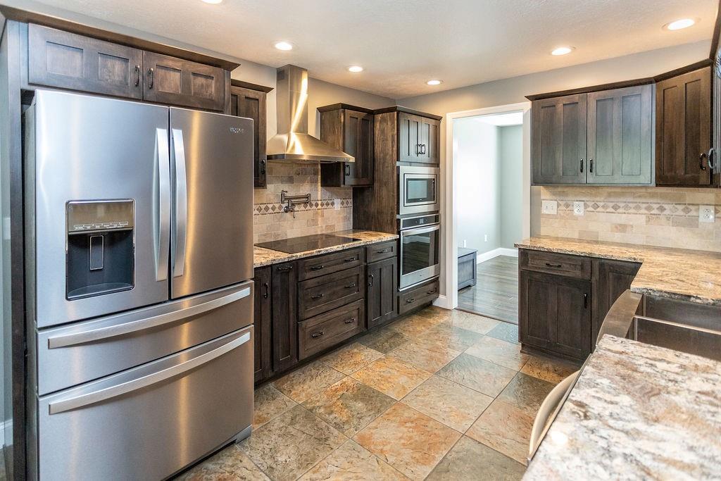 159 Reservoir Hill Road Uniontown, PA 15401 - Photo 17 of 50 a kitchen with stainless steel appliances granite countertop a refrigerator and a stove