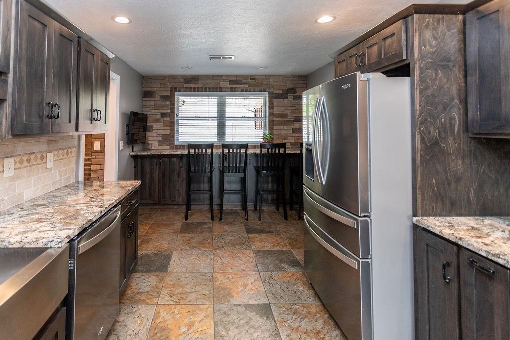 159 Reservoir Hill Road Uniontown, PA 15401 - Photo 18 of 50 a kitchen with stainless steel appliances granite countertop a refrigerator a sink and a stove