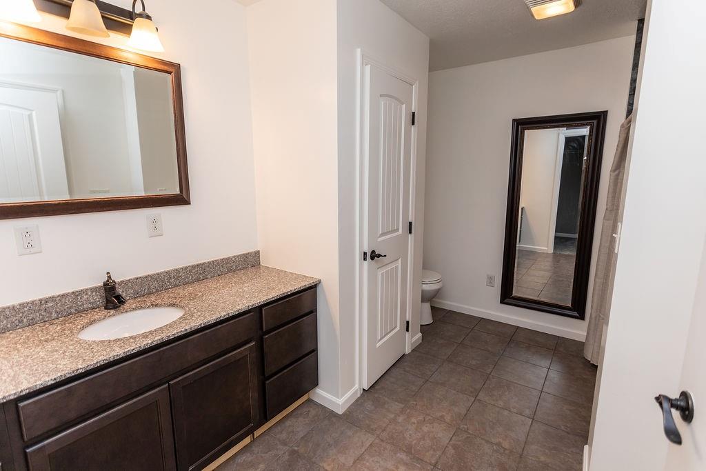 159 Reservoir Hill Road Uniontown, PA 15401 - Photo 25 of 50 a bathroom with a granite countertop sink a mirror and a