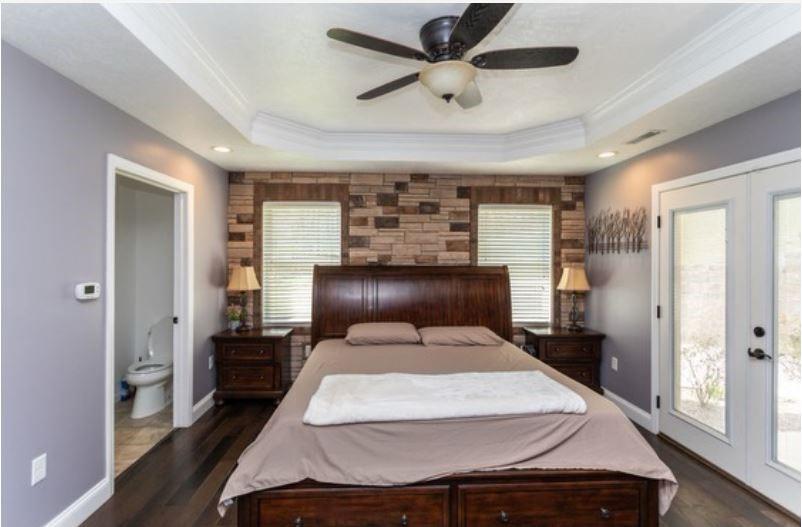 159 Reservoir Hill Road Uniontown, PA 15401 - Photo 31 of 50 a bedroom with a large bed and a chandelier