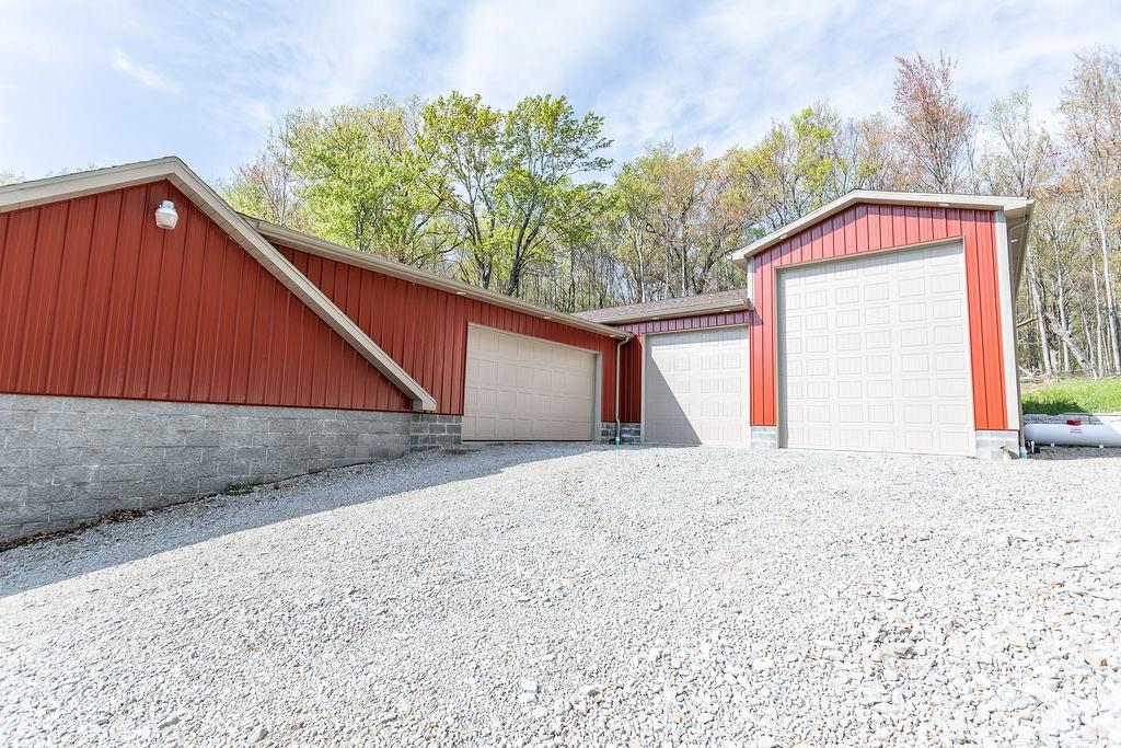 159 Reservoir Hill Road Uniontown, PA 15401 - Photo 46 of 50 a backyard of a house with large trees and garage