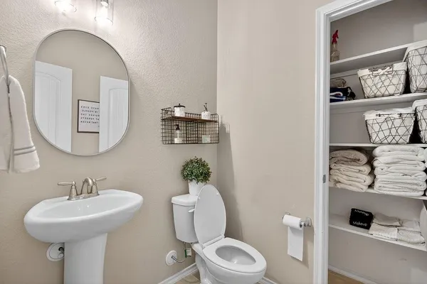 a bathroom with a toilet sink and mirror
