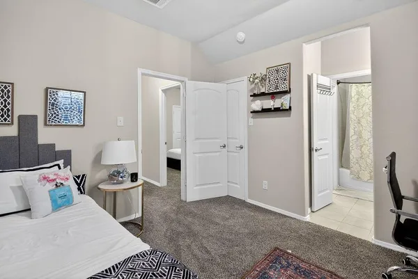 a bedroom with furniture and a rug
