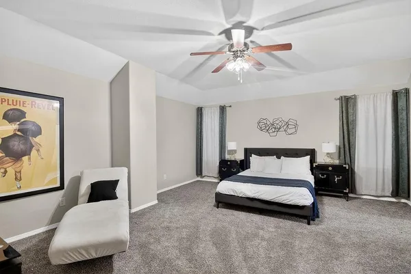 a bedroom with a bed and a couch