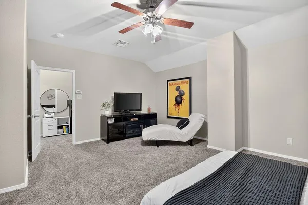 a living room with furniture a chandelier and a flat screen tv