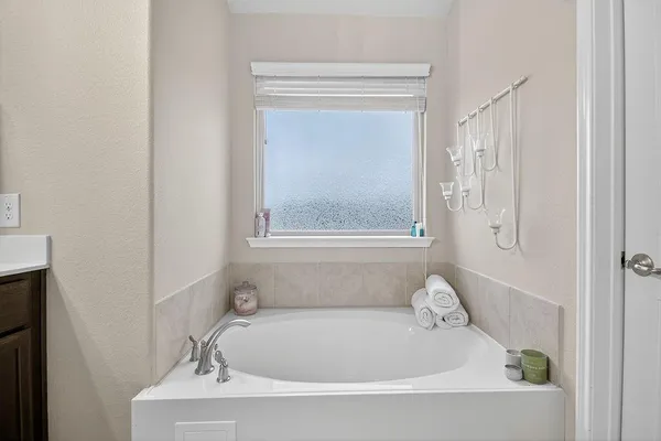 a white bath tub sitting next to a window