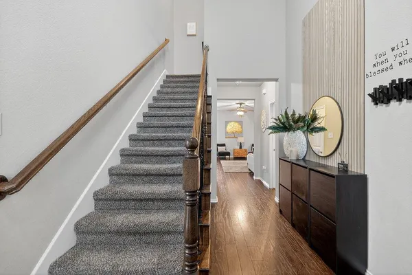 a view of entryway and hall with wooden floor