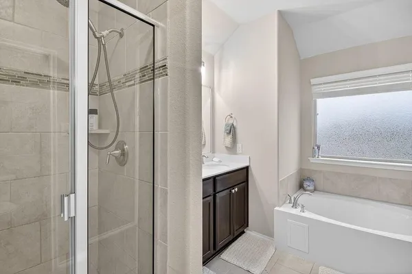 a bathroom with a tub shower and sink