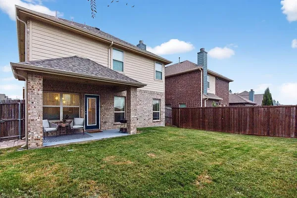 a view of a house with a yard and furniture
