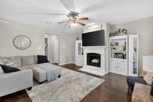 a living room with furniture a fireplace and a flat screen tv