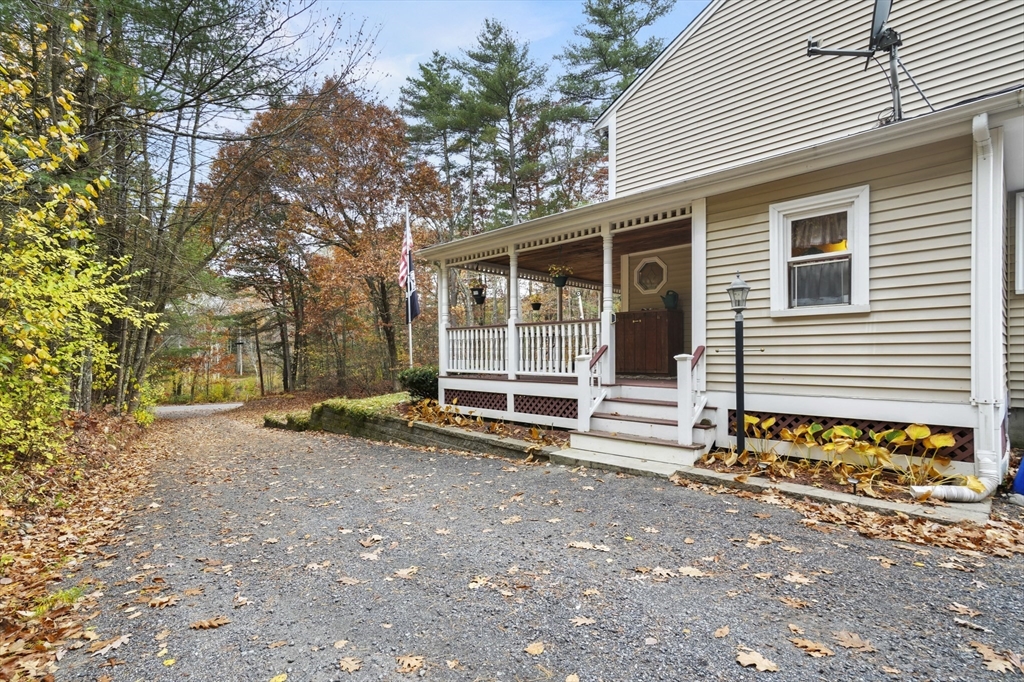 79 Whitney Road Shirley, MA 01464 - Photo 4 of 35 a view of a house with a yard and garage