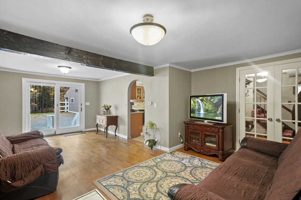 79 Whitney Road Shirley, MA 01464 - Photo 8 of 35 a bedroom with furniture and a flat screen tv