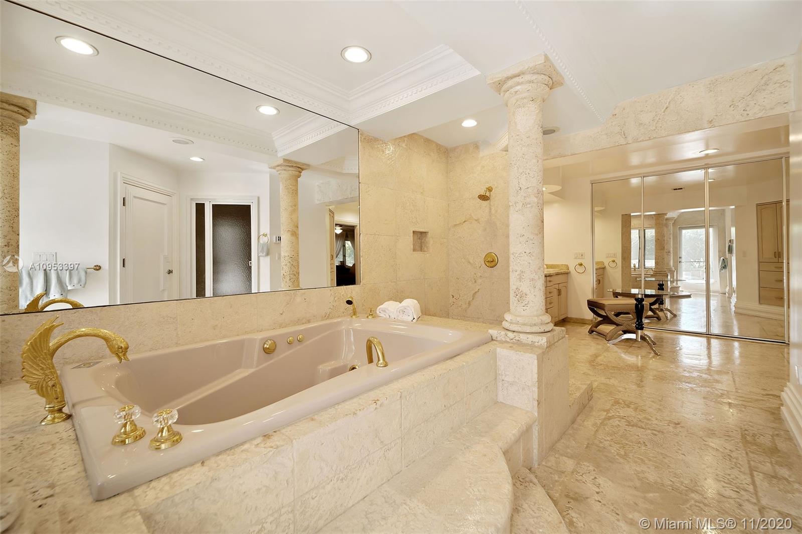 9100 Southwest 103rd Street Miami, FL 33176 - Photo 18 of 47 a spacious bathroom with a tub a double vanity mirror and shower