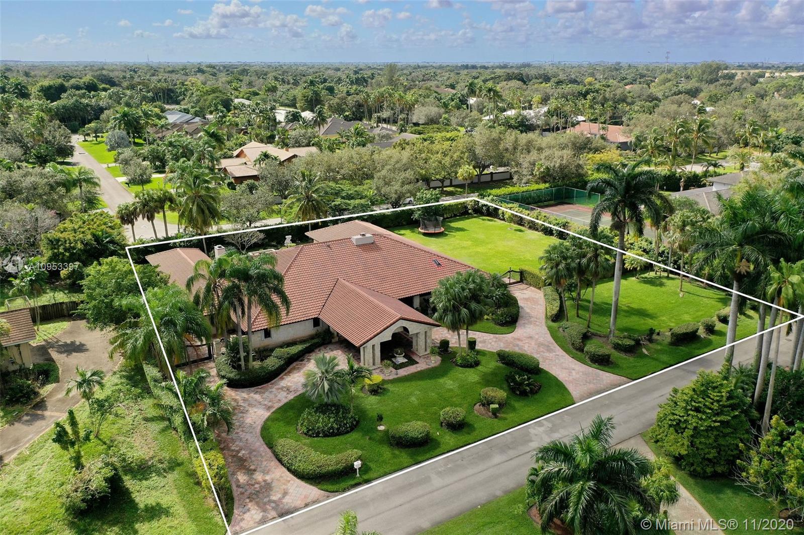 9100 Southwest 103rd Street Miami, FL 33176 - Photo 3 of 47 an aerial view of a house with a yard and lake