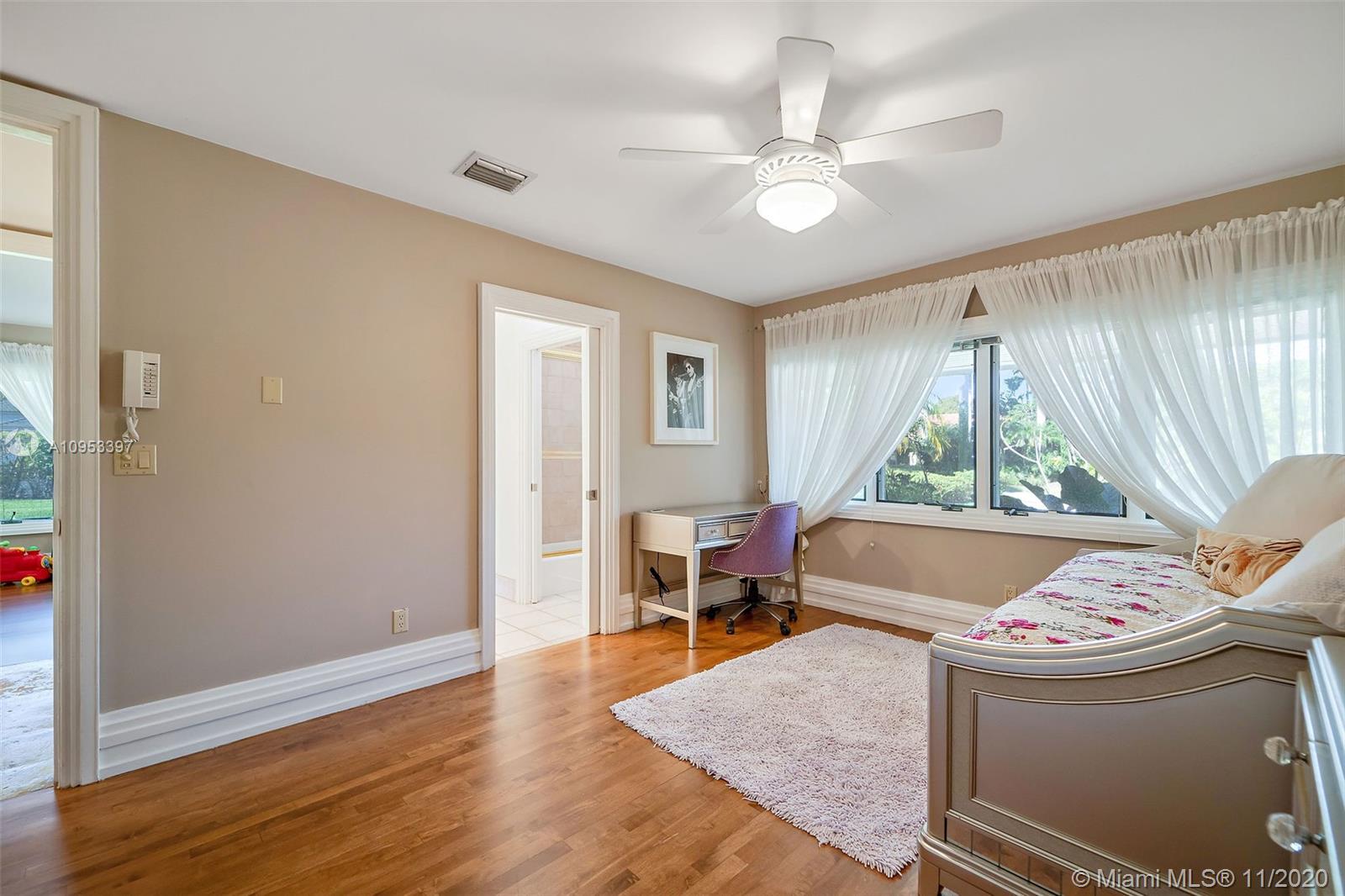 9100 Southwest 103rd Street Miami, FL 33176 - Photo 27 of 47 a living room with a window and a dining table