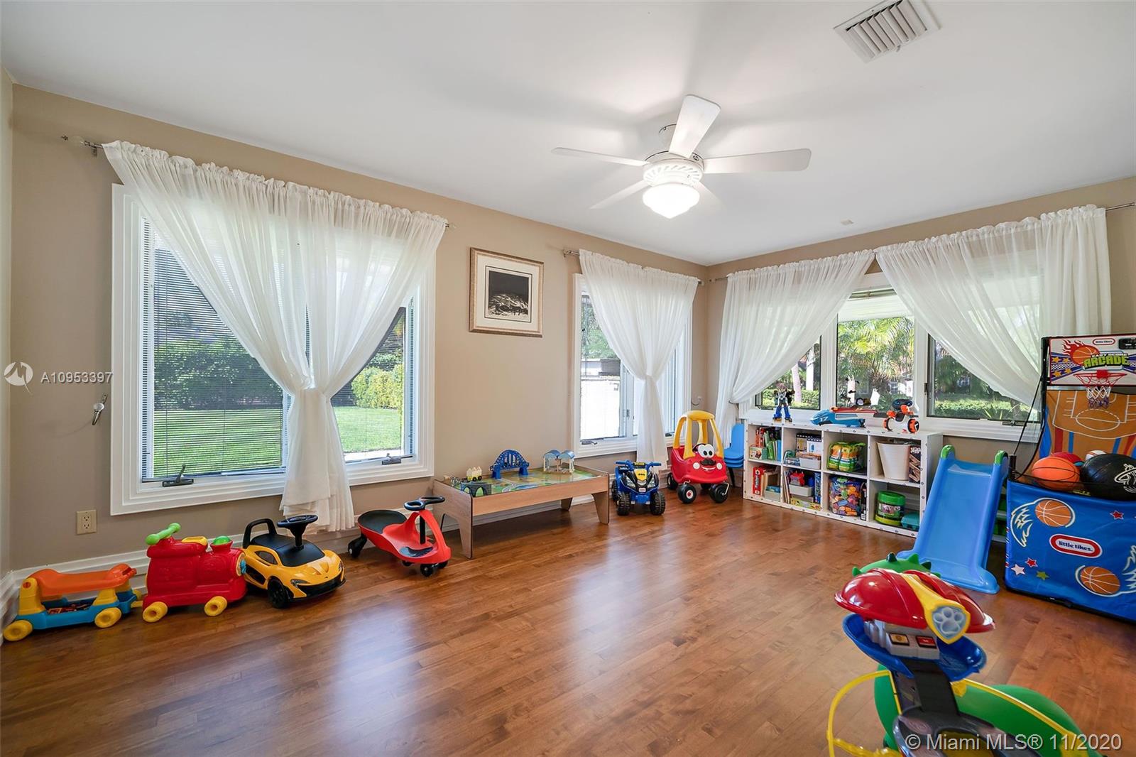 9100 Southwest 103rd Street Miami, FL 33176 - Photo 29 of 47 a living room with lots of toys and wooden floor