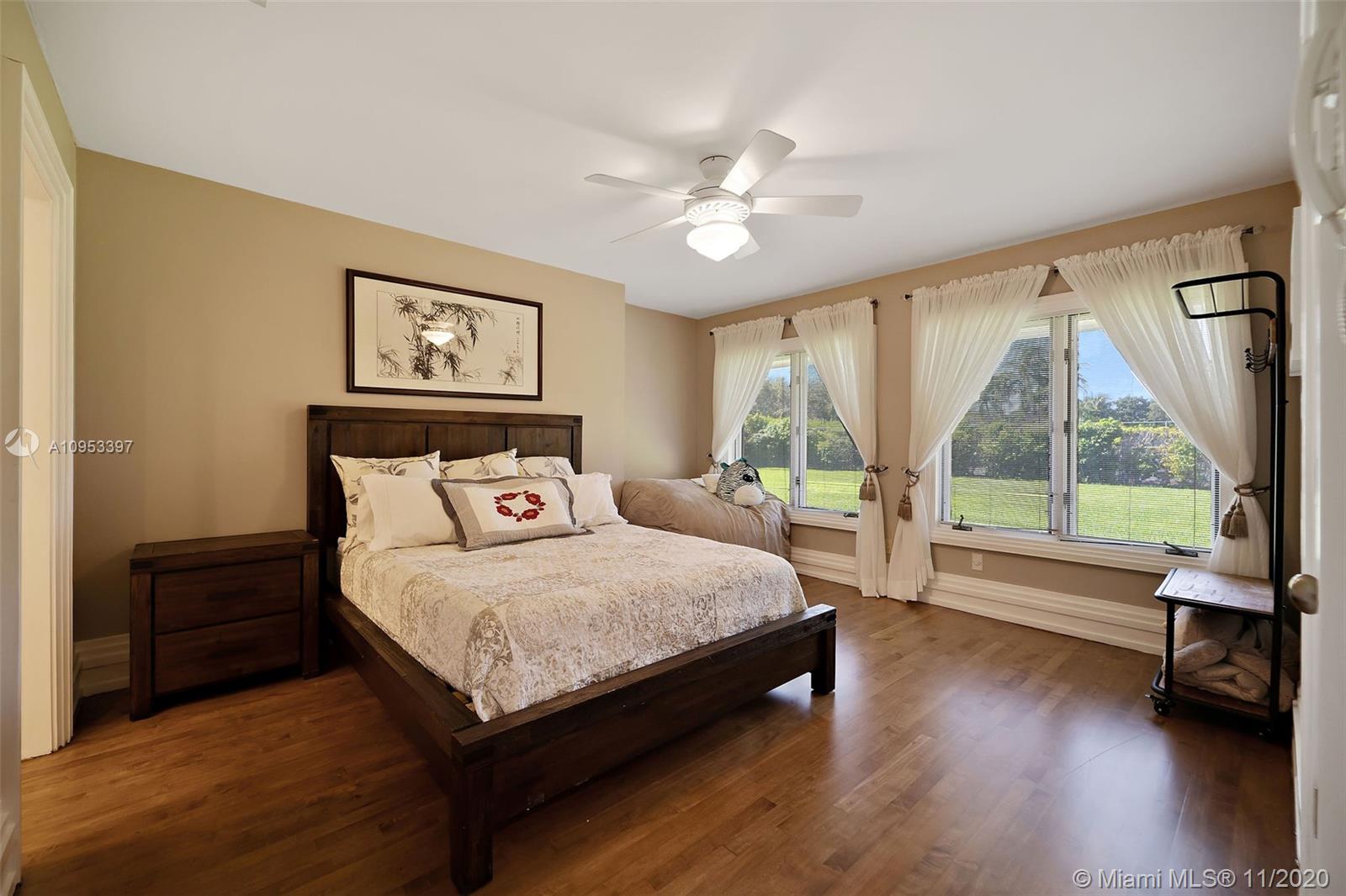 9100 Southwest 103rd Street Miami, FL 33176 - Photo 30 of 47 a bedroom with a large bed and a large window