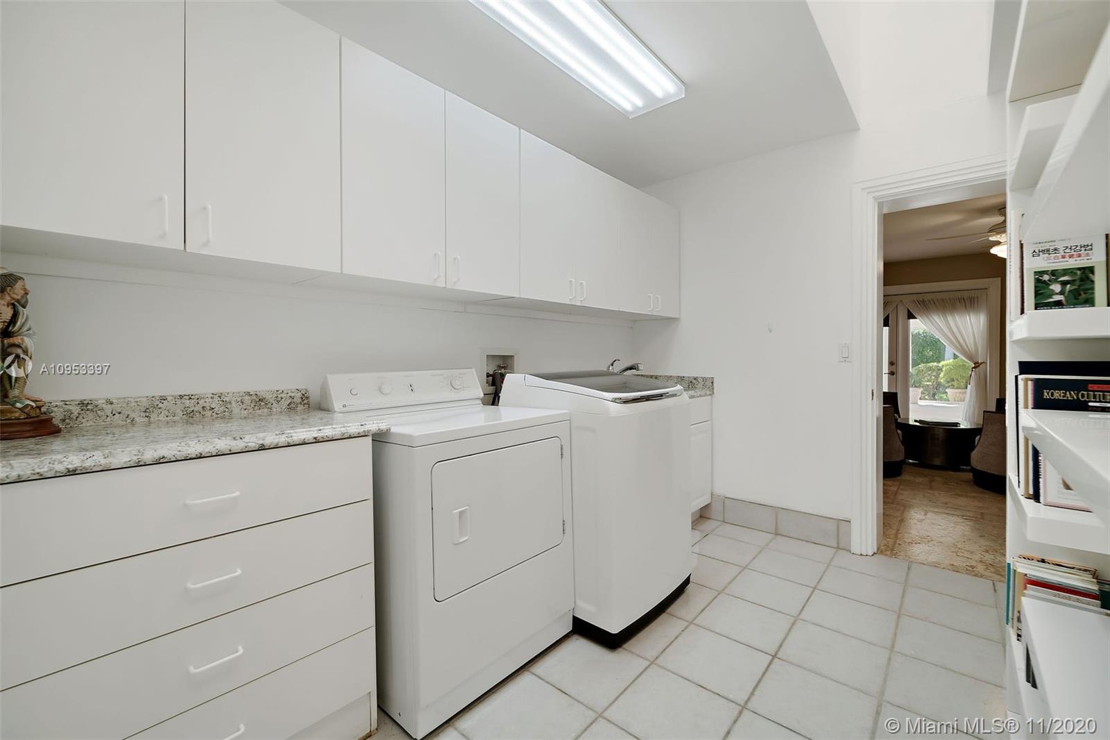 9100 Southwest 103rd Street Miami, FL 33176 - Photo 32 of 47 a utility room with cabinets washer and dryer