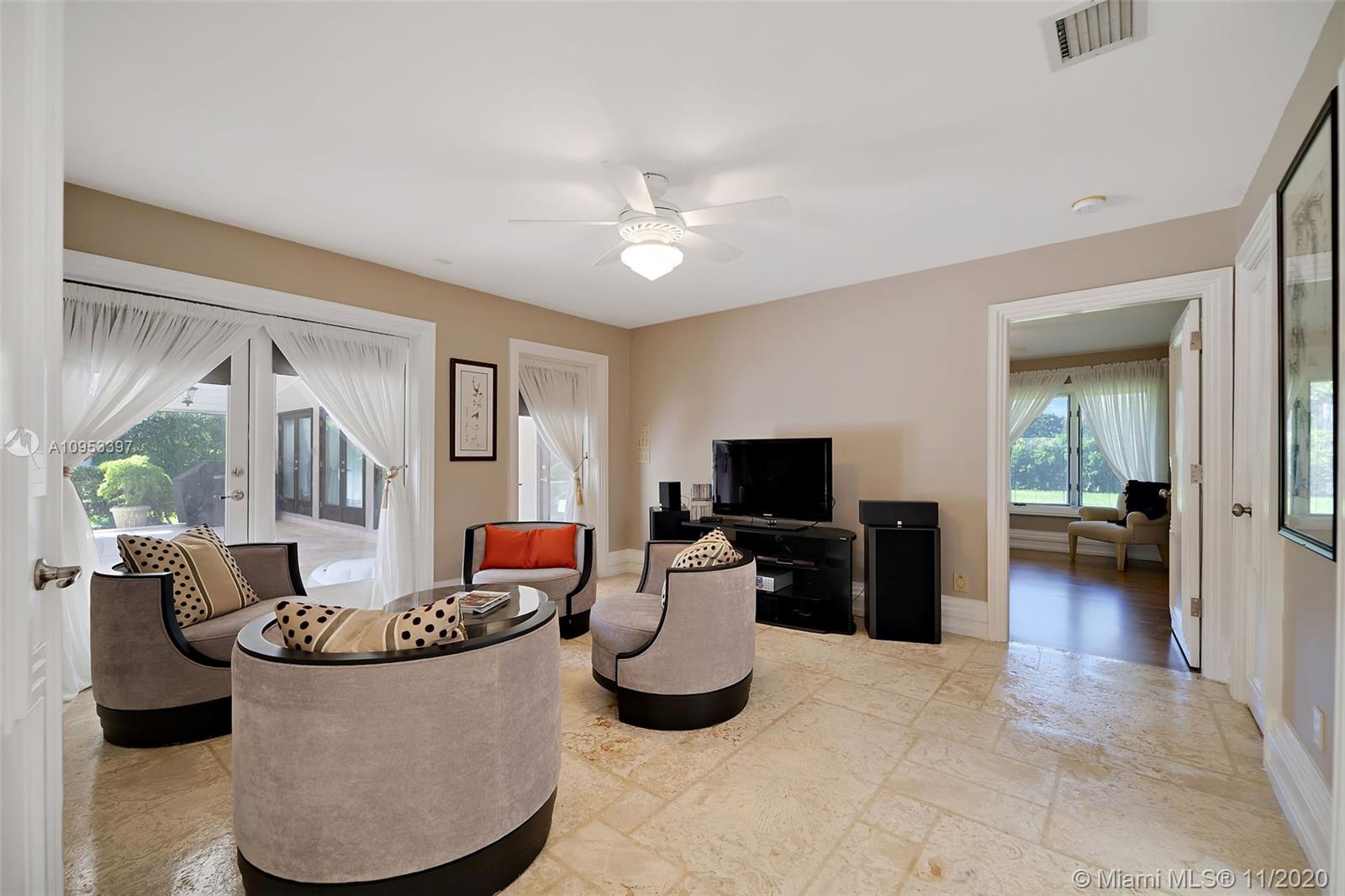 9100 Southwest 103rd Street Miami, FL 33176 - Photo 33 of 47 a living room with furniture and a flat screen tv