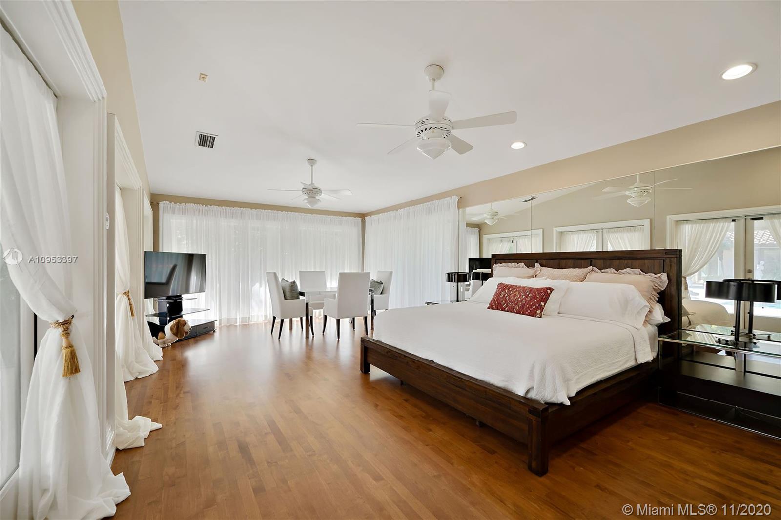 9100 Southwest 103rd Street Miami, FL 33176 - Photo 37 of 47 a spacious bedroom with a bed and a table