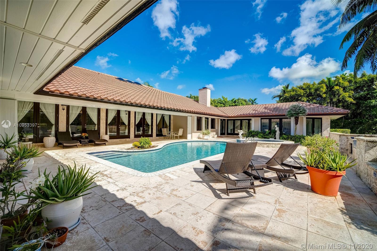 9100 Southwest 103rd Street Miami, FL 33176 - Photo 42 of 47 a view of a house with backyard sitting area and swimming pool