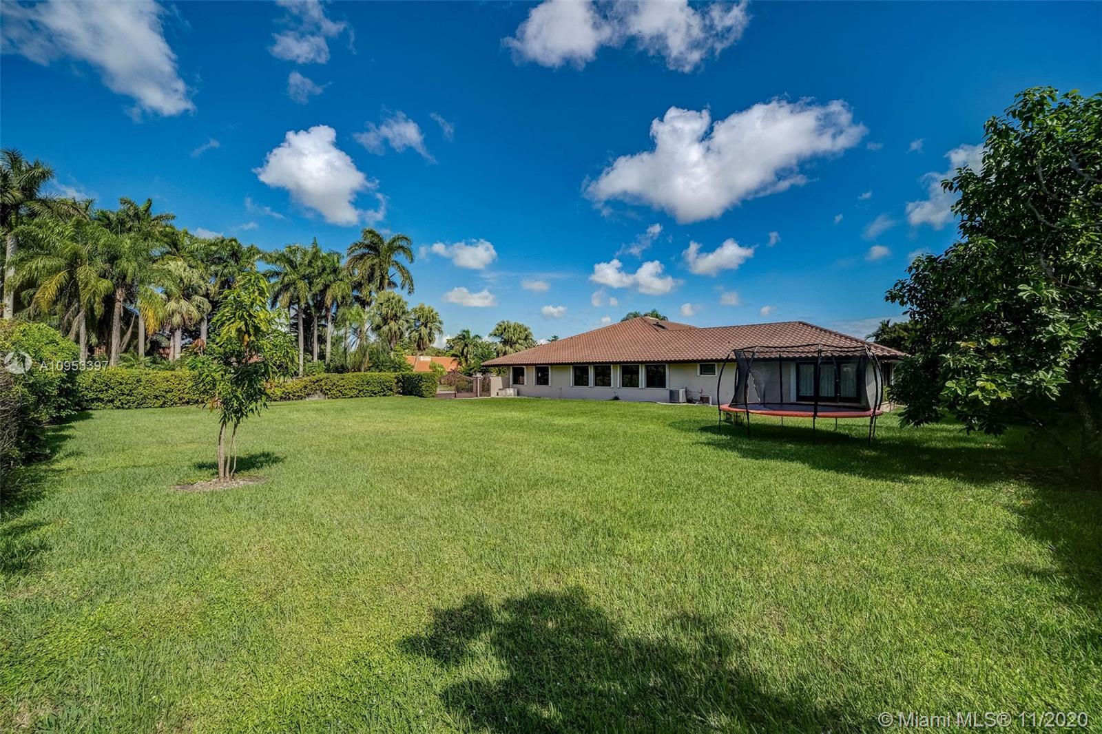 9100 Southwest 103rd Street Miami, FL 33176 - Photo 46 of 47 a view of a house with a backyard