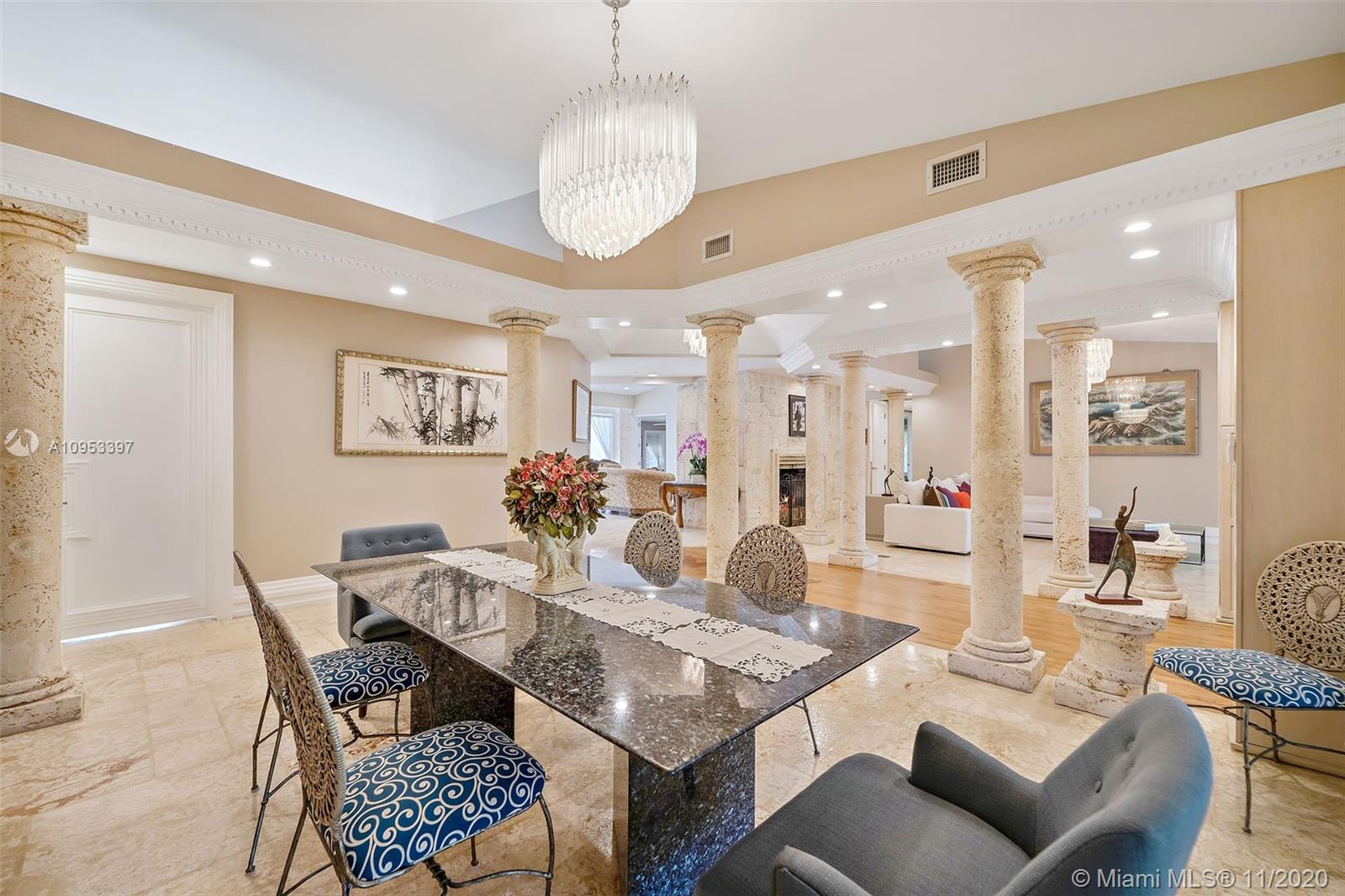 9100 Southwest 103rd Street Miami, FL 33176 - Photo 9 of 47 a dining room with furniture a rug and a chandelier