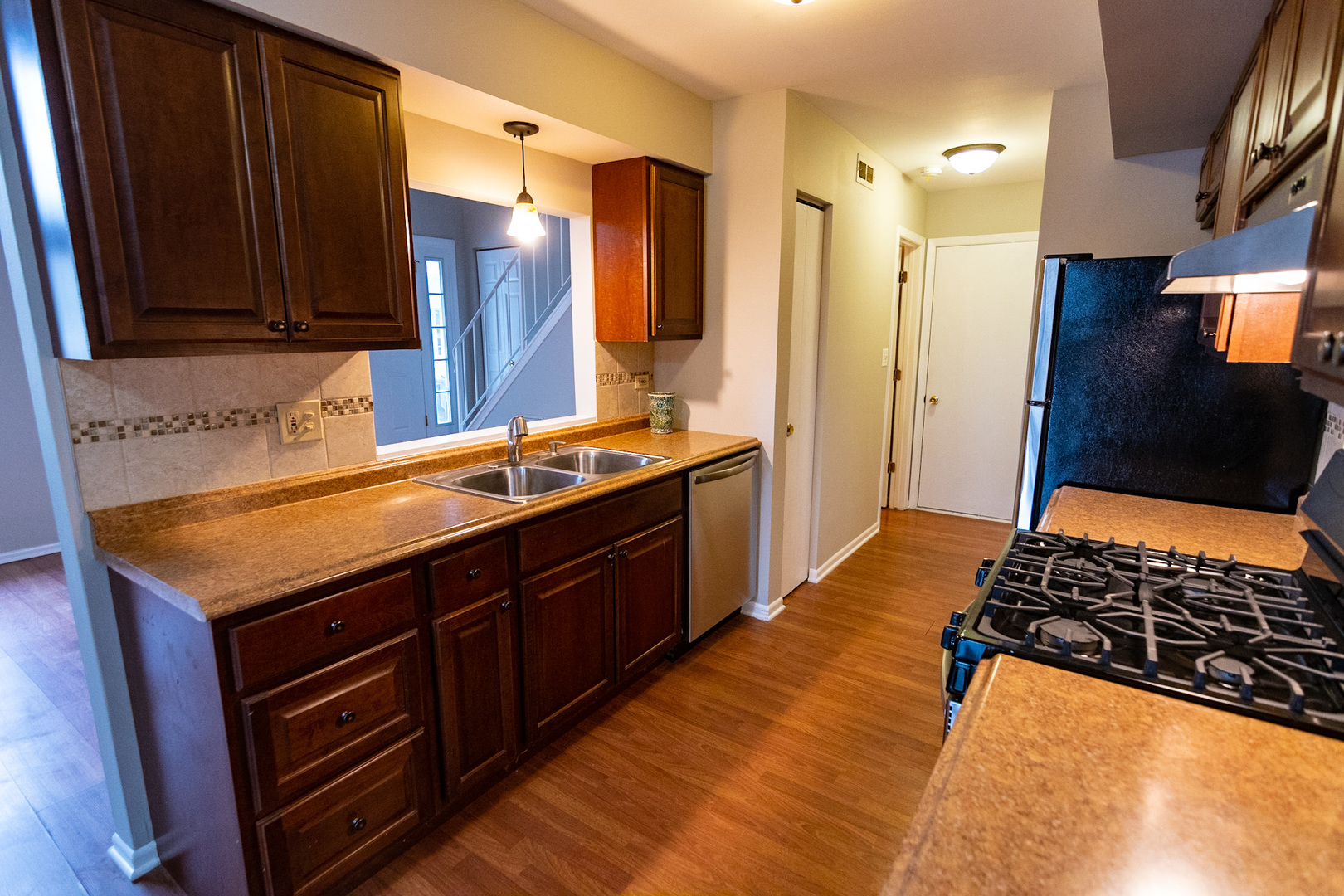 232 Butternut Lane, Unit 232 Streamwood, IL 60107 - Photo 7 of 16 a kitchen with stainless steel appliances granite countertop a sink stove and refrigerator